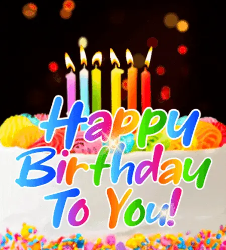 Kolorowy tort urodzinowy z p�on�cymi �wieczkami i kolorowym napisem Happy Birthday To You