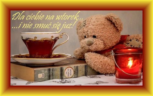 Pluszowy mi�, elegancka fili�anka z napojem na ksi��ce oraz zapalona czerwona �wieca
