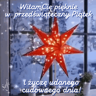 Świecąca czerwona gwiazda adwentowa na tle zimowego okna i napis Witam Cię pięknie